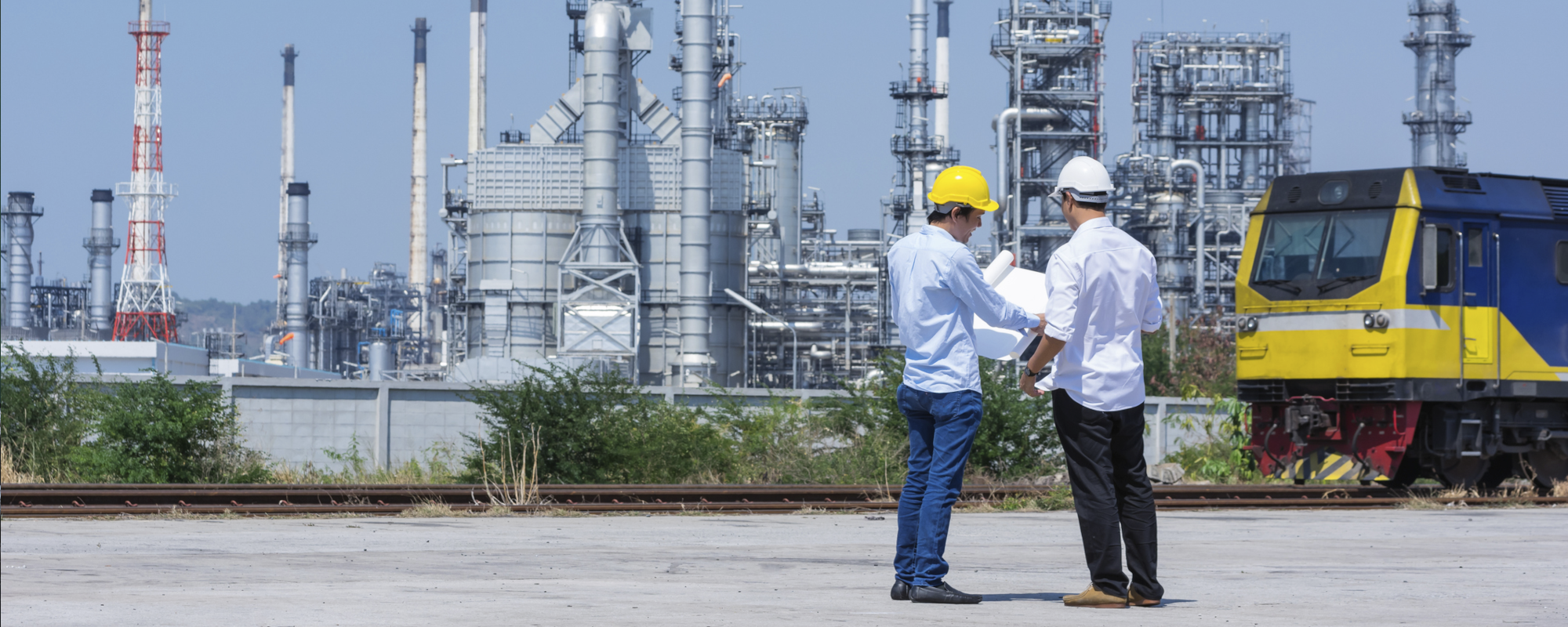 Environmental consultant reviewing regulatory documents at an industrial facility.