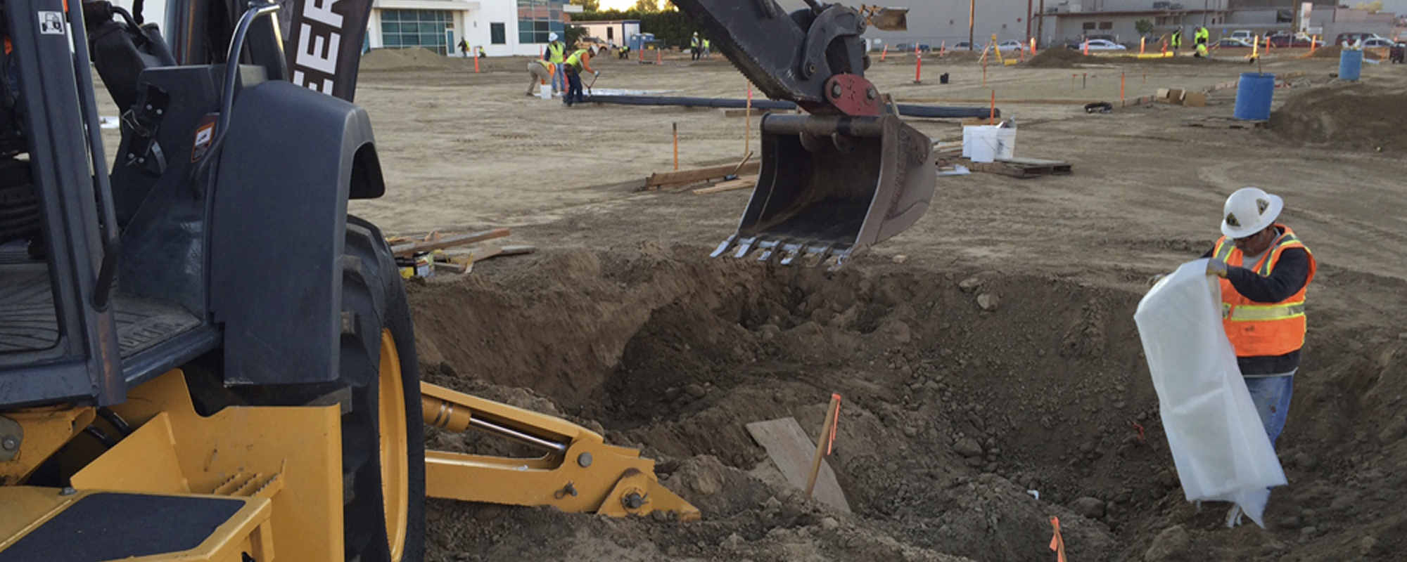 Excavator loading impacted soil during a remedial excavation.