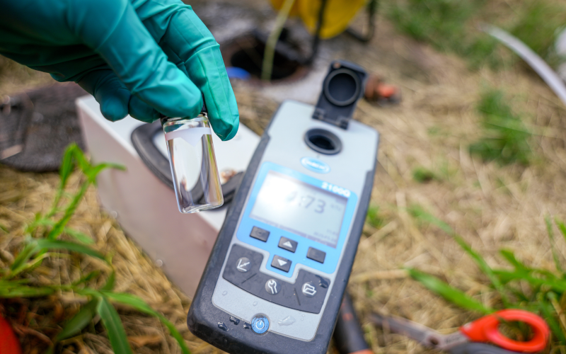 Technician collecting soil and groundwater samples in the field.